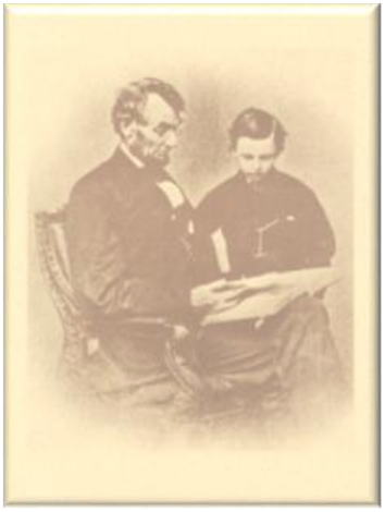An elderly man and woman seated, looking at a book together.